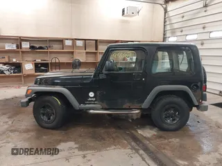 2003 Jeep Wrangler Sport Right Hand Drive with VIN 1J4F449S63P359031, listed as a IAAI auction lot 41495087 with 126,678 mi miles. Bid and sale history available at carsss.com. Image 14.