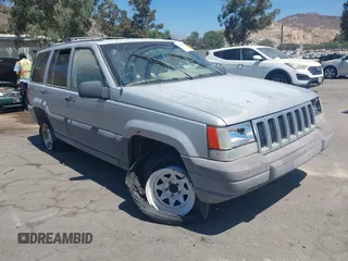 1997 Jeep Grand Cherokee Laredo with VIN 1J4GZ58S4VC720943, listed as a IAAI auction lot 42648807 with 231,203 mi miles and . Bid and sale history available at DreamBid. Image 1.