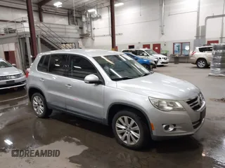 2010 Volkswagen Tiguan SEL with VIN WVGAV7AXXAW512143, listed as a IAAI auction lot 42527111 with 96,988 mi miles and . Bid and sale history available at DreamBid. Image 1.