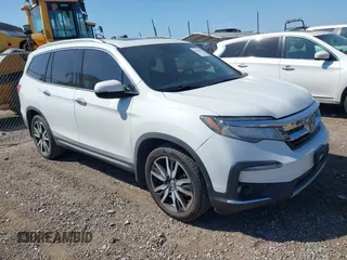 2021 Honda Pilot Touring 8-Passenger with VIN 5FNYF5H95MB001847, listed as a IAAI auction lot 42010050 with 76,667 mi miles and . Bid and sale history available at DreamBid. Image 1.