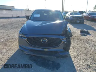 2021 Mazda CX-5 Touring with VIN JM3KFACM1M0371354, listed as a IAAI auction lot 40938490 with 56,172 mi miles. Bid and sale history available at carsss.com. Image 12.