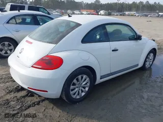 2016 Volkswagen Beetle Coupe 1.8T Wolfsburg Edition with VIN 3VWF17AT0GM607755, listed as a IAAI auction lot 41508585 with 52,913 mi miles. Bid and sale history available at carsss.com. Image 4.