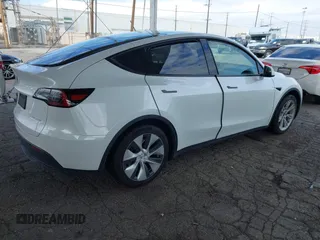 2023 Tesla Model Y Long Range with VIN 7SAYGAEE7PF607195, listed as a IAAI auction lot 41819147 with 74,694 mi miles. Bid and sale history available at carsss.com. Image 4.