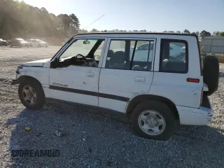 1997 Geo Tracker LSi z VIN 2CNBE1360V6927915, wystawiony jako Copart lot #53469605 z przebiegiem 119 413 mil mil oraz Szkody całkowita. Historia ofert i sprzedaży dostępna na DreamBid. Obrazek 2.