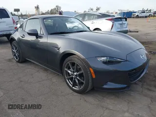 2020 Mazda MX-5 Miata Grand Touring z VIN JM1NDAM72L0414750, wystawiony jako IAAI lot #41399542 z przebiegiem 12 683 mil mil oraz . Historia ofert i sprzedaży dostępna na DreamBid. Obrazek 1.