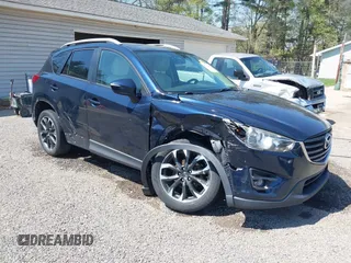 2016 Mazda CX-5 Grand Touring with VIN JM3KE4DY5G0681369, listed as a IAAI auction lot 42102805 with 128,182 mi miles and . Bid and sale history available at DreamBid. Image 1.