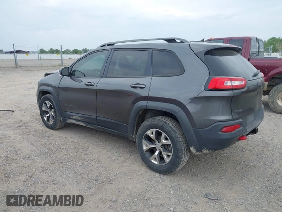 2015 Jeep Cherokee Trailhawk with VIN 1C4PJMBSXFW654754, listed as a IAAI auction lot 39935278 with 128,076 mi miles and . Bid and sale history available at DreamBid. Image 3.