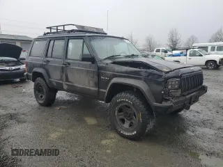 1996 Jeep Cherokee Sport with VIN 1J4FJ68S0TL288244, listed as a Copart auction lot 87801025 with 218,356 mi miles and Salvage Title. Bid and sale history available at carsss.com. Image 4.