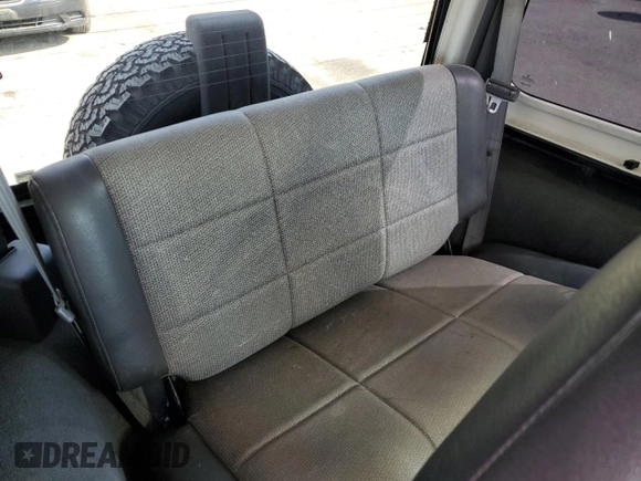 1999 Jeep Wrangler Sport z VIN 1J4FY19SXXP465037, wystawiony jako Copart lot #54772405 z przebiegiem 50 942 mil mil oraz Nie do naprawy • Non repairable. Historia ofert i sprzedaży dostępna na DreamBid. Obrazek 10.