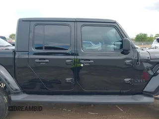 2021 Jeep Gladiator Freedom z VIN 1C6HJTAG4ML586999, wystawiony jako IAAI lot #41911751 z przebiegiem 81 030 mil mil oraz . Historia ofert i sprzedaży dostępna na DreamBid. Obrazek 13.