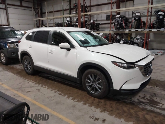 2022 Mazda CX-9 Sport z VIN JM3TCBBYXN0603653, wystawiony jako IAAI lot #42325893 z przebiegiem 57 480 mil mil oraz . Historia ofert i sprzedaży dostępna na DreamBid. Obrazek 1.