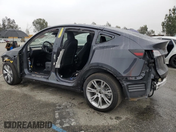 2024 Tesla Model Y with VIN 7SAYGDED5RF093410, listed as a Copart auction lot 50557225 with 6,396 mi miles and Salvage Title. Bid and sale history available at DreamBid. Image 2.