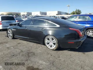 2014 Jaguar XJ with VIN SAJWA2GZXE8V59542, listed as a Copart auction lot 73672614 with 105,328 mi miles and Salvage Title. Bid and sale history available at carsss.com. Image 2.