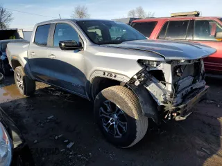 2023 GMC Canyon 4WD AT4 with VIN 1GTP6DEK5P1170230, listed as a Copart auction lot 42701935 with 26,704 mi miles and Salvage Title. Bid and sale history available at carsss.com. Image 4.