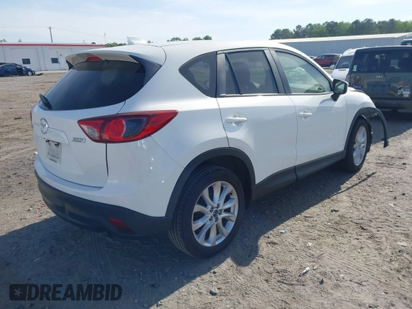 2015 Mazda CX-5 Grand Touring with VIN JM3KE2DY5F0498718, listed as a IAAI auction lot 42070000 with 129,327 mi miles. Bid and sale history available at carsss.com. Image 4.