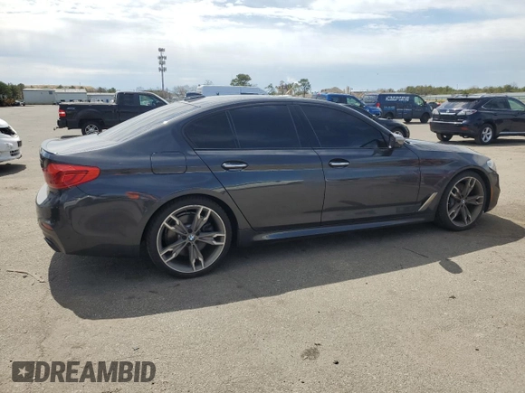 2018 BMW 5 Series M550i xDrive with VIN WBAJB9C57JB286734, listed as a Copart auction lot 52711235 with 127,450 mi miles and Salvage title. Bid and sale history available at DreamBid. Image 3.