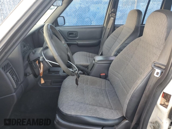 1999 Jeep Cherokee Sport with VIN 1J4FT68S6XL578679, listed as a Copart auction lot 76697394 with 196,110 mi miles and Salvage title. Bid and sale history available at DreamBid. Image 7.