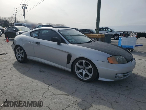 2003 Hyundai Tiburon GT z VIN KMHHN65F13U102985, wystawiony jako Copart lot #45294325 z przebiegiem 326 919 mil mil oraz Szkoda całkowita • Salvage title. Historia ofert i sprzedaży dostępna na DreamBid. Obrazek 4.