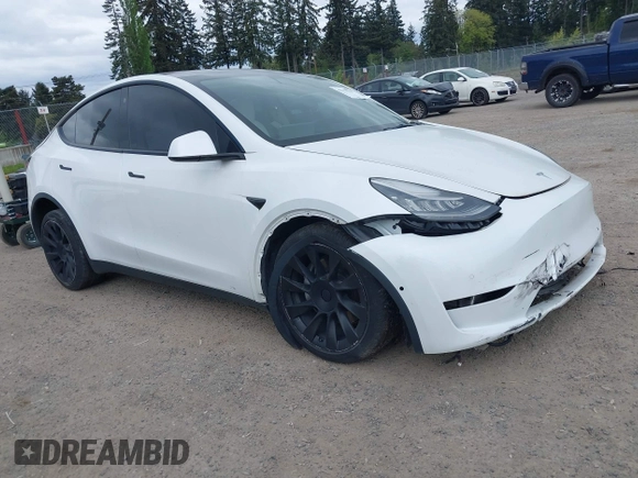 2021 Tesla Model Y Standard Range with VIN 5YJYGDED9MF121828, listed as a IAAI auction lot 42119518 with 34,454 mi miles and . Bid and sale history available at carsss.com. Image 1.