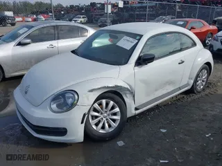 2016 Volkswagen Beetle Coupe 1.8T Wolfsburg Edition with VIN 3VWF17AT0GM607755, listed as a IAAI auction lot 41508585 with 52,913 mi miles. Bid and sale history available at carsss.com. Image 2.