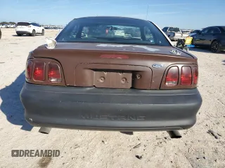 1997 Ford Mustang with VIN 1FALP4043VF174092, listed as a Copart auction lot 86983884 with 105,774 mi miles and Salvage Title. Bid and sale history available at carsss.com. Image 6.