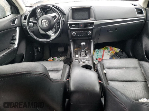 2016 Mazda CX-5 Grand Touring z VIN JM3KE2DY9G0687261, wystawiony jako Copart lot #52865415 z przebiegiem Nie podano mil oraz Szkoda całkowita • Salvage title. Historia ofert i sprzedaży dostępna na DreamBid. Obrazek 8.