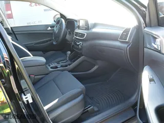 2019 Hyundai Tucson Value with VIN KM8J33A4XKU979791, listed as a IAAI auction lot 41255630 with 90,807 mi miles. Bid and sale history available at carsss.com. Image 5.