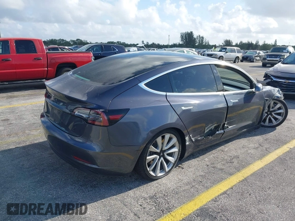 2020 Tesla Model 3 Standard Range Plus with VIN 5YJ3E1EA0LF744046, listed as a IAAI auction lot 41939894 with 102,576 mi miles. Bid and sale history available at carsss.com. Image 4.
