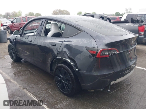 2025 Tesla Model Y Long Range with VIN 7SAYGDED8SA340082, listed as a IAAI auction lot 41915369 with 7,296 mi miles and . Bid and sale history available at DreamBid. Image 3.