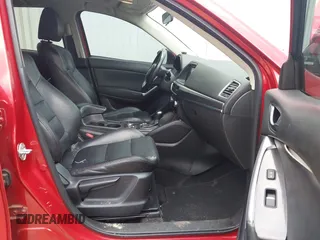 2016 Mazda CX-5 Grand Touring z VIN JM3KE2DY6G0693678, wystawiony jako IAAI lot #42443247 z przebiegiem 127 620 mil mil oraz . Historia ofert i sprzedaży dostępna na DreamBid. Obrazek 5.