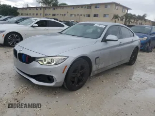 2015 BMW 4 Series 428i xDrive with VIN WBA4C9C59FD330853, listed as a Copart auction lot 52130785 with 128,618 mi miles and Salvage title. Bid and sale history available at DreamBid. Image 1.