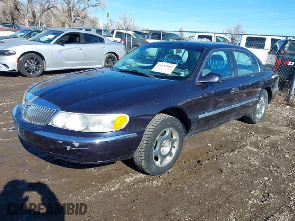 1999 Lincoln Continental with VIN 1LNHM97V8XY700644, listed as a IAAI auction lot 41641082 with 142,527 mi miles. Bid and sale history available at carsss.com. Image 2.