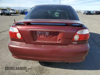2001 Kia Sephia z VIN KNAFB121015028494, wystawiony jako Copart lot #81581404 z przebiegiem 86 655 mil mil oraz Szkody całkowita. Historia ofert i sprzedaży dostępna na DreamBid. Obrazek 6.