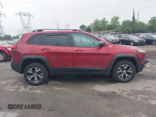 2015 Jeep Cherokee Trailhawk with VIN 1C4PJMBSXFW667469, listed as a IAAI auction lot 42438006 with 127,136 mi miles and . Bid and sale history available at DreamBid. Image 14.