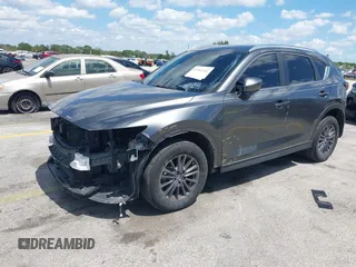 2020 Mazda CX-5 Touring with VIN JM3KFACM9L0826742, listed as a IAAI auction lot 41903755 with 73,409 mi miles and . Bid and sale history available at DreamBid. Image 2.