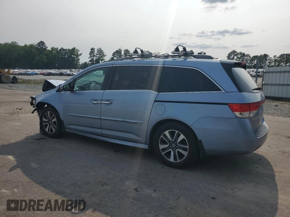 2014 Honda Odyssey Touring with VIN 5FNRL5H95EB080449, listed as a Copart auction lot 58489715 with 154,604 mi miles and Salvage title. Bid and sale history available at DreamBid. Image 2.