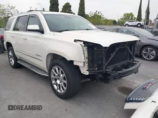2015 GMC Yukon Denali with VIN 1GKS2CKJ9FR294551, listed as a IAAI auction lot 42162654 with 106,063 mi miles. Bid and sale history available at carsss.com. Image 1.