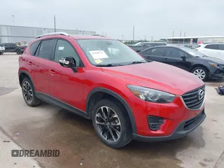 2016 Mazda CX-5 Grand Touring z VIN JM3KE2DY2G0602387, wystawiony jako IAAI lot #41908732 z przebiegiem 194 046 mil mil oraz . Historia ofert i sprzedaży dostępna na DreamBid. Obrazek 1.