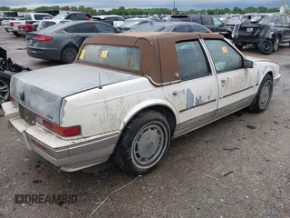 1990 Cadillac Seville z VIN 1G6KY533XLU803161, wystawiony jako IAAI lot #42164352 z przebiegiem Nie podano mil oraz . Historia ofert i sprzedaży dostępna na DreamBid. Obrazek 4.
