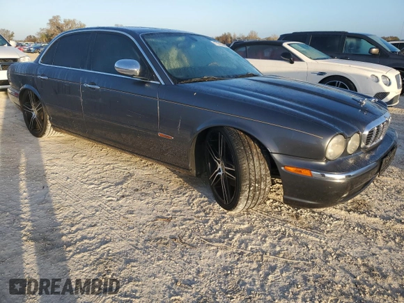 2004 Jaguar XJ with VIN SAJEA74C24SG09038, listed as a Copart auction lot 77015544 with Not Provided miles and Salvage Title. Bid and sale history available at DreamBid. Image 4.