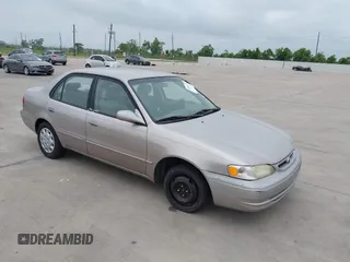 1999 Toyota Corolla VE z VIN 1NXBR12E0XZ160343, wystawiony jako IAAI lot #42311179 z przebiegiem 130 083 mil mil oraz . Historia ofert i sprzedaży dostępna na DreamBid. Obrazek 1.