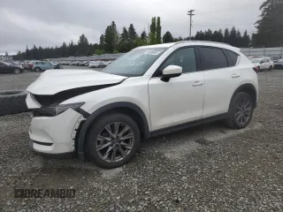 2021 Mazda CX-5 Signature with VIN JM3KFBEY3M0410998, listed as a Copart auction lot 54868885 with 73,207 mi miles and Salvage Title. Bid and sale history available at carsss.com. Image 1.