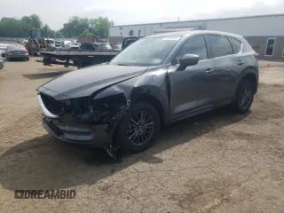 2021 Mazda CX-5 Touring z VIN JM3KFBCM0M1300548, wystawiony jako Copart lot #57485395 z przebiegiem 65 615 mil mil oraz Szkoda całkowita • Salvage title. Historia ofert i sprzedaży dostępna na DreamBid. Obrazek 1.