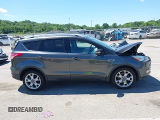 2015 Ford Escape Titanium z VIN 1FMCU9J92FUB01007, wystawiony jako IAAI lot #42319246 z przebiegiem 90 782 mil mil oraz . Historia ofert i sprzedaży dostępna na DreamBid. Obrazek 14.
