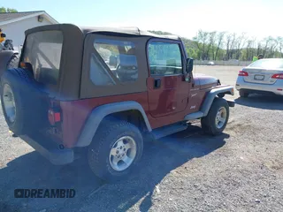 2002 Jeep Wrangler Sport with VIN 1J4FA49SX2P713303, listed as a IAAI auction lot 42136848 with 152,822 mi miles. Bid and sale history available at carsss.com. Image 4.