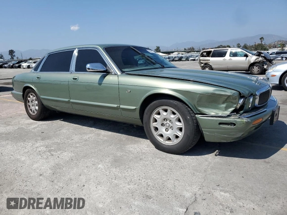 1999 Jaguar XJ with VIN SAJHX604XXC854217, listed as a Copart auction lot 56042735 with 127,092 mi miles and Salvage title. Bid and sale history available at DreamBid. Image 4.