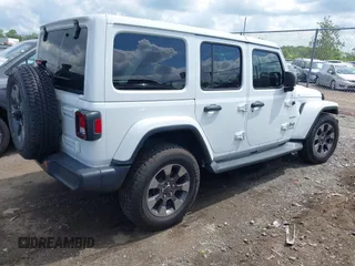 2018 Jeep Wrangler Unlimited Sahara with VIN 1C4HJXEG1JW205789, listed as a IAAI auction lot 42435877 with 57,587 mi miles and . Bid and sale history available at DreamBid. Image 4.