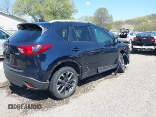 2016 Mazda CX-5 Grand Touring with VIN JM3KE4DY5G0681369, listed as a IAAI auction lot 42102805 with 128,182 mi miles and . Bid and sale history available at DreamBid. Image 4.