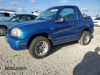 2001 Suzuki Vitara JLS z VIN 2S3TC52C116101163, wystawiony jako Copart lot #74469744 z przebiegiem Nie podano mil oraz Szkody całkowita. Historia ofert i sprzedaży dostępna na DreamBid. Obrazek 1.