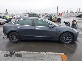 2018 Tesla Model 3 Long Range Battery with VIN 5YJ3E1EB7JF114305, listed as a IAAI auction lot 41765994 with 76,945 mi miles and . Bid and sale history available at DreamBid. Image 14.